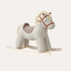A blue and white striped rocking horse with a red bridle and mane, on a white background.