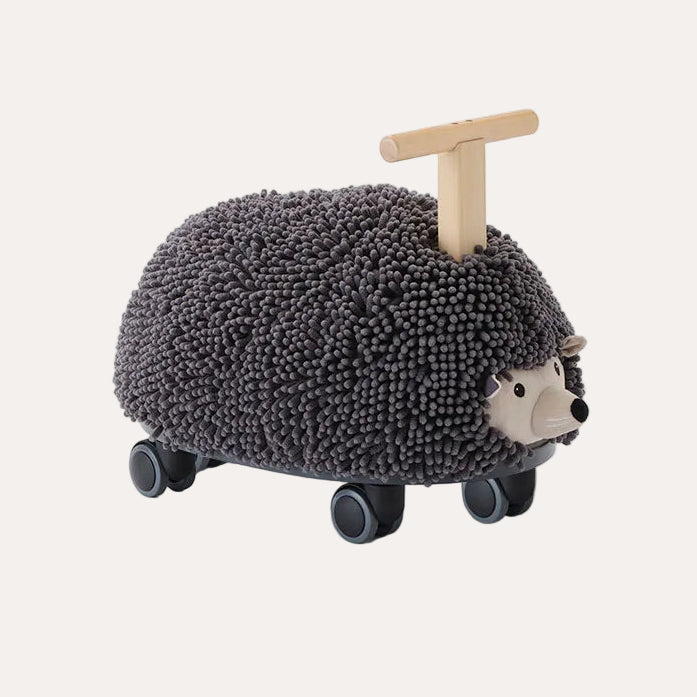 Hedgehog-shaped toy with wheels and a wooden handle on a white background