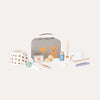 Collection of baby care items including a gray suitcase, teddy bear, and various bottles on a white background