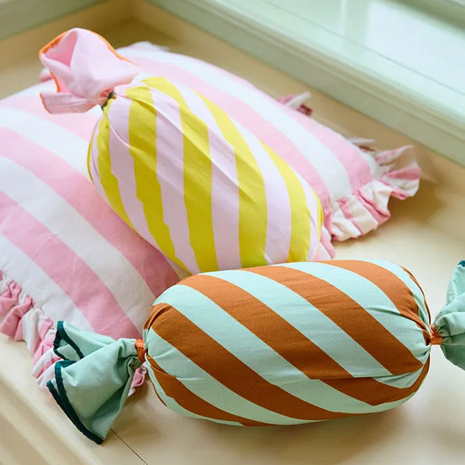 Colorful striped cushions on a wooden surface