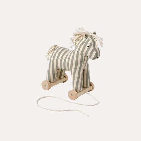 Striped toy horse on wheels with a string for pulling on a white background