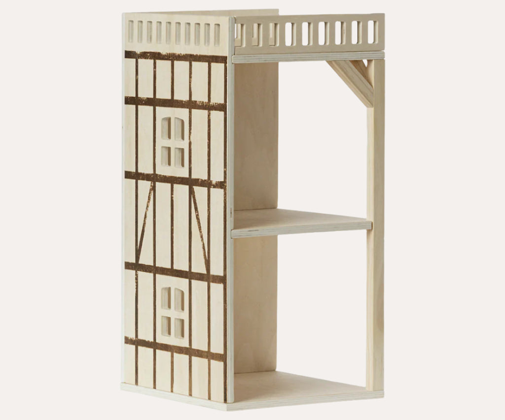 Wooden dollhouse with two levels on a white background