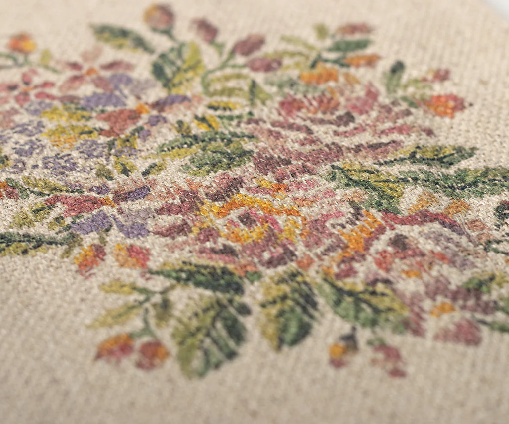Close-up of a cross-stitched floral pattern on fabric