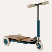Maileg blue mouse kick board with cream wheels and grips, silver handlebars and a strap across the platform.