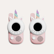 Two The Zoofamily Unicorn walkie-talkies with white faces, pastel horns, pink bodies and round black screens.