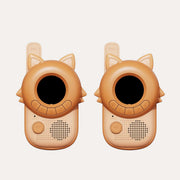 Two The Zoofamily Fox walkie-talkies with orange pointed ears, round black screens and pale speaker panels.