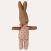 Knitted toy rabbit with a pink bow and polka dot dress on a white background