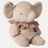 Beige plush elephant toy with a ruffled bow on a white background