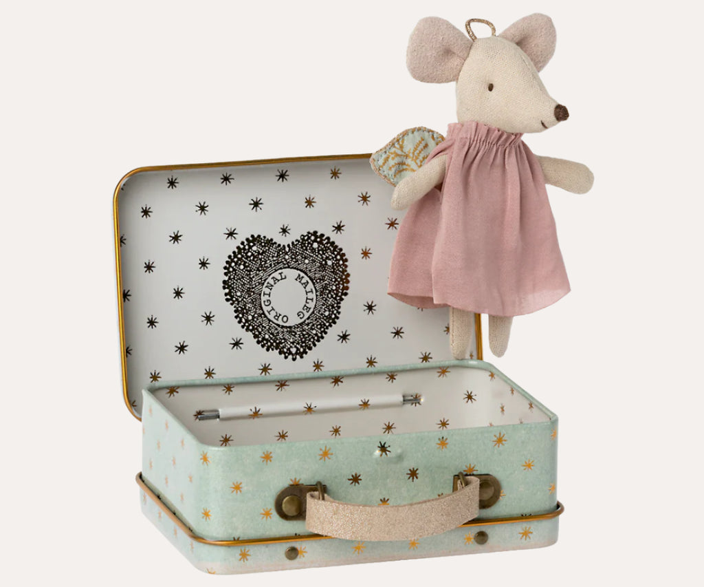 Small stuffed mouse toy in a suitcase with a heart design on a white background