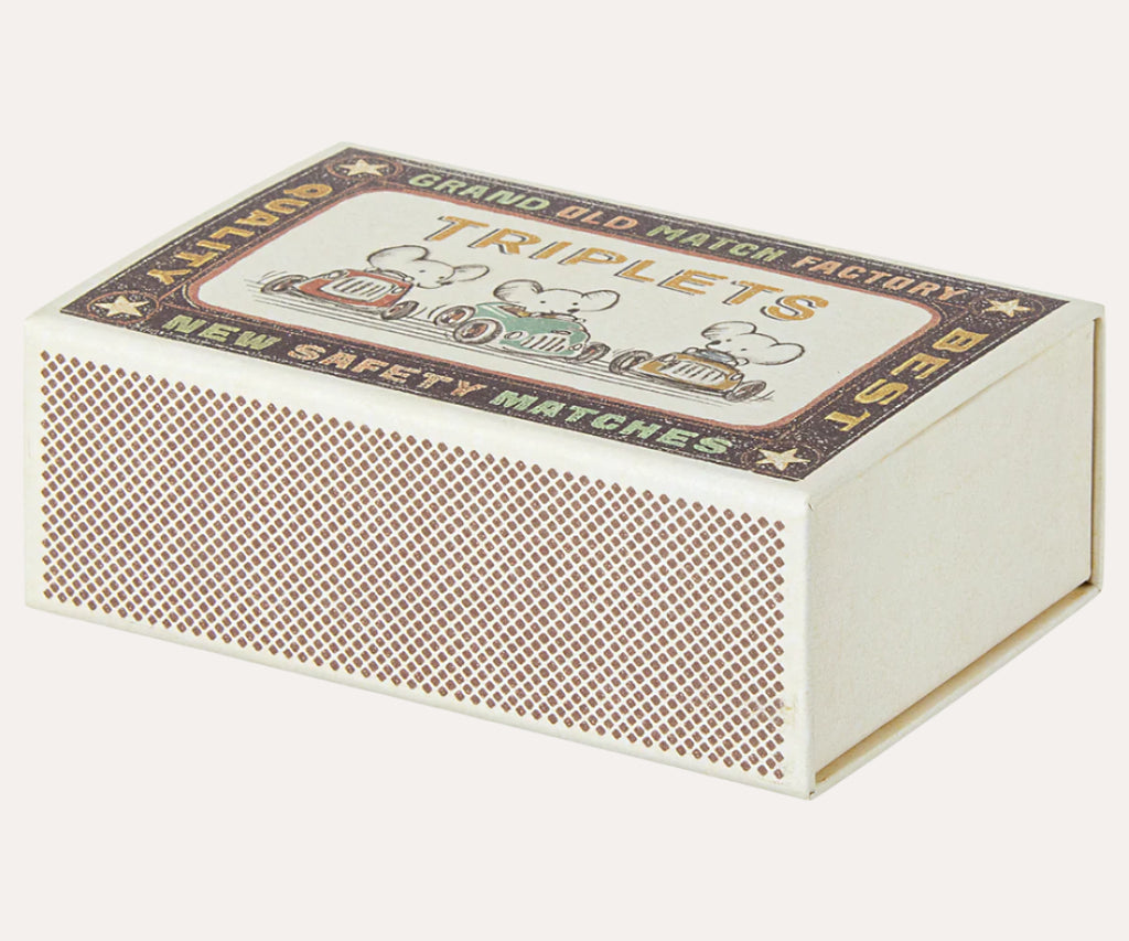 Vintage-style matchbox with decorative label on a white background