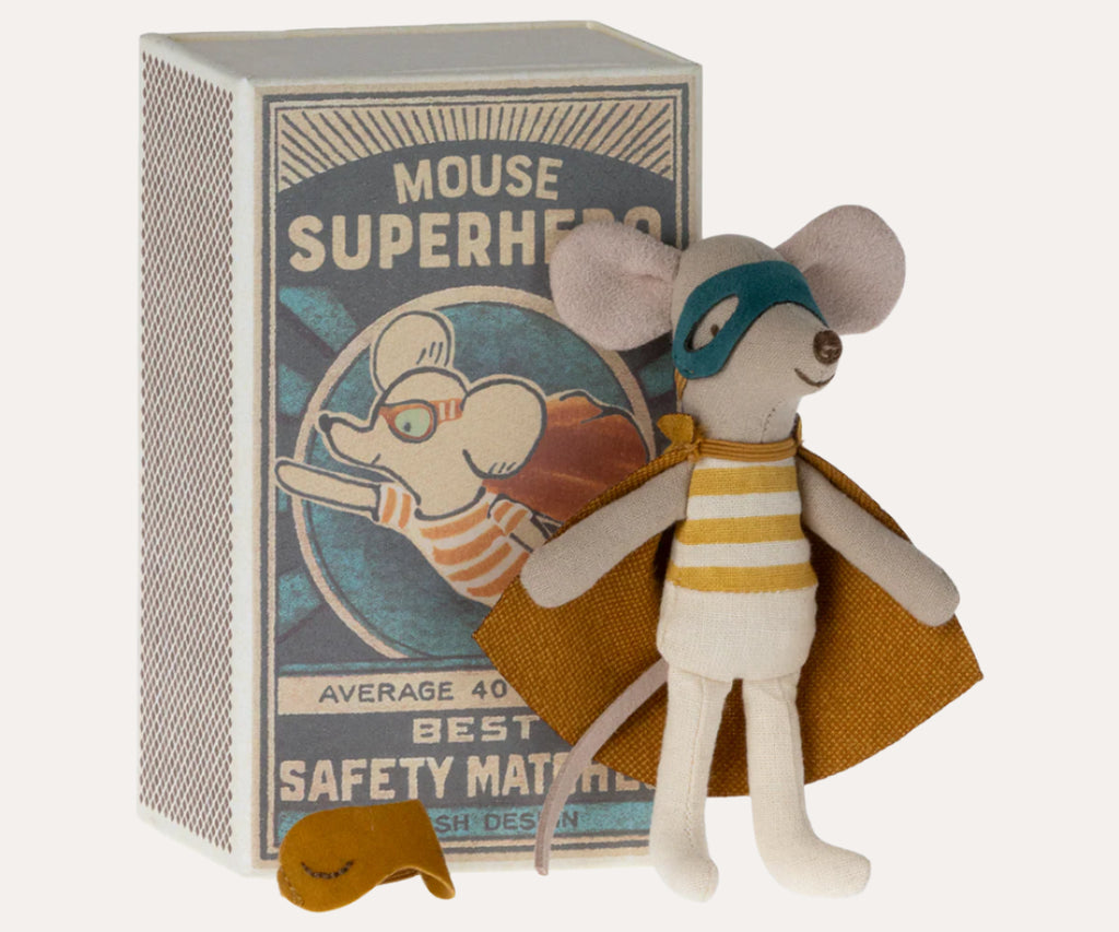 Toy mouse dressed as a superhero with cape and mask next to a box labeled 'Mouse Superheroes'.