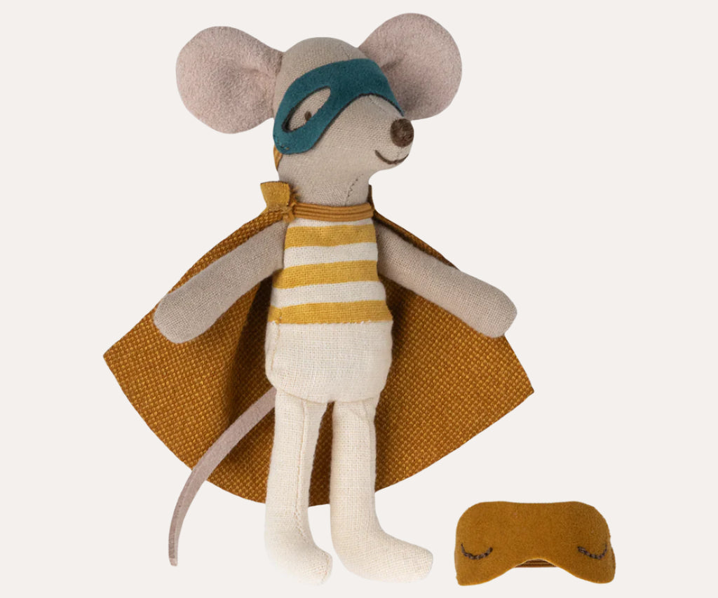 Toy mouse in superhero costume with cape and mask on a white background