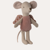 Stuffed toy mouse with a pink dress on a white background