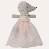 Stuffed animal toy with a lace dress on a white background