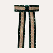 Mimi & Lula Green Circus Glitter Bow with gold glitter stripes, dotted edging and two long tails.