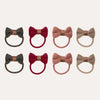 Set of eight bow-shaped hair ties in various colors on a white background