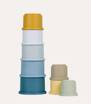 Little Dutch Blue Stacking Cups in a tall blue-and-yellow tower with smaller pastel cups beside it.