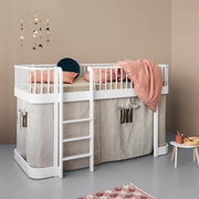 Oliver Furniture white Original low loft bed with a front ladder, pale curtains beneath and a pink blanket above.