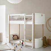Oliver Furniture Mini+ low loft bed in White/Oak with a right-hand ladder, styled with cushions and toys beneath.