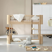 Oliver Furniture Mini+ low loft bed in Oak with a right-hand ladder, styled with pale bedding and toys beneath.
