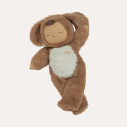 Stuffed toy resembling a brown animal with a white belly on a beige background