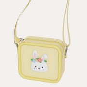 The Zoofamily Rabbit Zoo Bag in yellow with a white flower-crowned rabbit face, zip closure and matching shoulder strap.