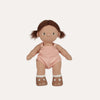 Doll with pink overalls on a white background