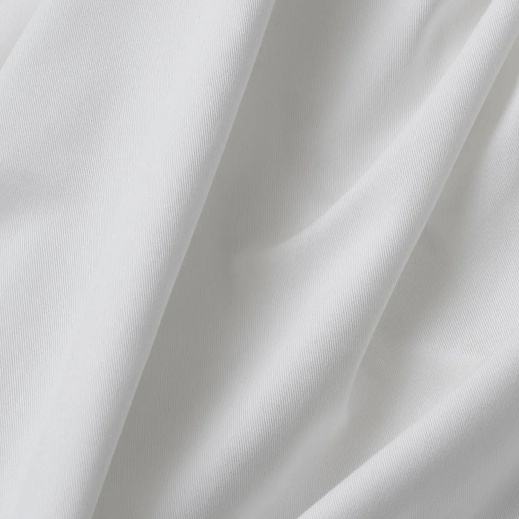 Close-up of white fabric with folds on a white background