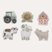 Little Dutch Little Farm 6 in 1 Puzzle designs laid out as a tractor, sunflower, barn, cow, sheep and pig.