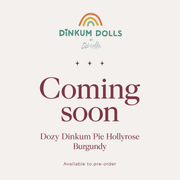 Coming soon graphic for Dinkum Dolls by Olli Ella, featuring a small rainbow logo above the brand name and the text 'Coming soon' in large burgundy lettering, with 'Dozy Dinkum Pie Hollyrose Burgundy' and 'Available to pre-order' below on a light beige background.