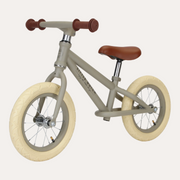 Little Dutch Olive Matte Balance Bike in three-quarter view with cream tyres and brown saddle and grips.