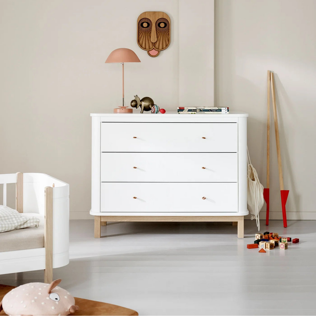 White dresser with toys in a child's room