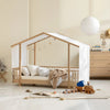 Children's room with a wooden crib and toys on a light-colored floor.