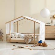 Oliver Furniture Original House Bed in Oak with bedding and a white canopy in a children's room.
