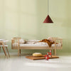 Children's room with wooden crib, toys, and a pendant light on a light green wall.