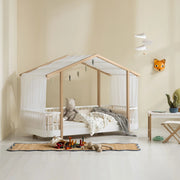 Oliver Furniture Wood Original House Bed in White/Oak, styled with bedding and a white canopy.