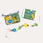 Cotton Twist Wildflower Bracelet Gift Kit with an open tin, green lid and a strand of colourful flower and round beads.