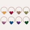 Set of colorful heart-shaped hair ties on a white background