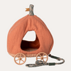 Pumpkin-shaped pet house with wheels and a leash on a white background