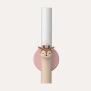The Zoofamily Deer portable night light upright in its dusty pink circular holder, with a deer detail on the handle.