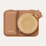 The Zoofamily Bear instant print camera with a brown body, mustard lens cover and a small bear-face detail.