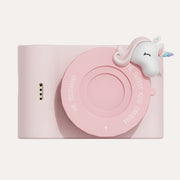 The Zoofamily Urban Zoo Unicorn camera in pale pink with a round pink lens cover and small white unicorn detail.