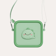 The Zoofamily Dino Zoo Bag with a pale green front, darker edging, smiling dinosaur badge and slim shoulder strap.