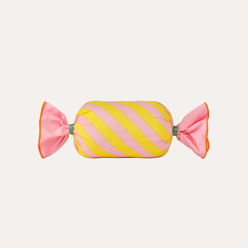 Striped candy with pink and yellow colors on a light green background