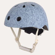 A light blue bicycle helmet with a subtle floral paisley pattern, featuring multiple ventilation holes and cream-colored chin straps, shown against a plain white background.