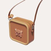 The Zoofamily Bear Zoo Bag with a brown front, mustard edging, small bear-face badge and brown shoulder strap.