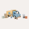 Wooden toy truck with boxes and figures on a white background