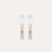 Two wooden spoons with light-colored handles on a white background
