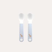 Two baby spoons with embroidered designs on a light gray background