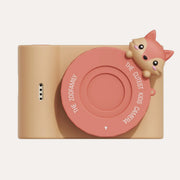 The Zoofamily Urban Zoo Fox camera with a golden body, coral-pink round lens cover and small fox-face detail.